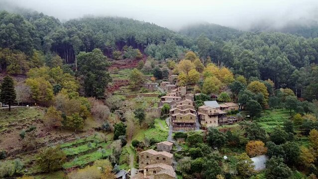 Aerial drone view of Cerdeira xisto schist shale village in Lousa, Portugal, going forward, close