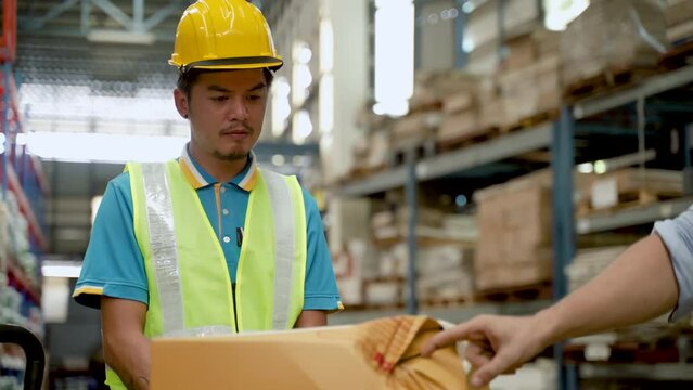 4K, Asian male employee color close-up, standing in front damaged product box, listened supervisor admonish about damaged move, In order not happen again prevent warehouse from causing problems later.