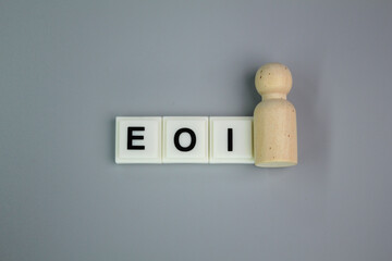 A wooden figure with the letters EOI or Expression of Interest lie. the concept of someone lying