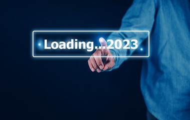 Hand using smartphone search on bar for loading 2023, start new year 2023 concept
