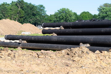 Drain and sewer pipes at a residential construction site - obrazy, fototapety, plakaty