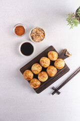Takoyaki is Japanese Street Food containing with octopus, sausage or cheese. garnish with seaweed and katsuobushi