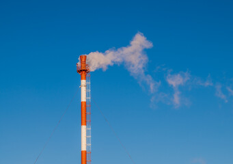 Smoke is coming from the pipe of the gas boiler house