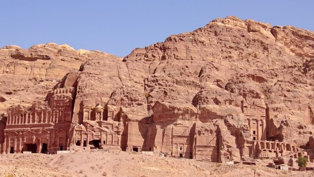 Top view tourist visit sightseeing Royal tombs structures in ancient city of Petra, Jordan. It is know as the Loculi. Petra has led to its designation as UNESCO World Heritage Site