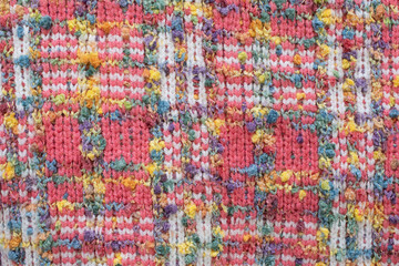 knitted sweater background texture. Real knitted fabric textured background. Colorful sweater texture. Background with knitted bright colorful sweater pattern. 