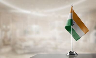 A small India flag on an abstract blurry background - 555310599