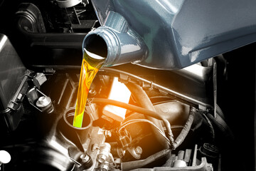 Fototapeta premium Refueling and pouring oil quality into the engine motor car Transmission and Maintenance Gear .Energy fuel concept.