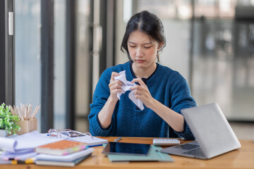 Fototapeta premium Portrait of tired young business Asian woman work with documents tax laptop computer in office. Sad, unhappy, Worried, Depression, or employee life stress concept.