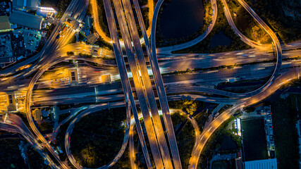 Aerial drone photo of ring road multi level circular junction road, road junction.Aerial view of the transportation,traffic,route and expressway.Night city traffic on 4-way street intersection circle.