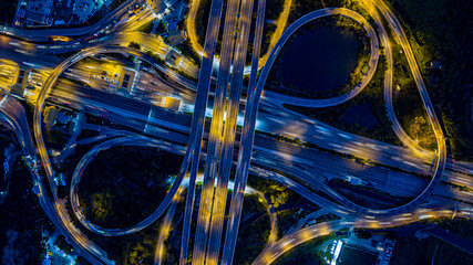 Aerial drone photo of ring road multi level circular junction road, road junction.Aerial view of the transportation,traffic,route and expressway.Night city traffic on 4-way street intersection circle.