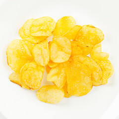 Salted potato chips of golden color on a white background.