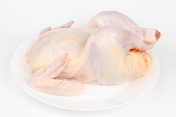 Whole raw chicken on a white plate. Diet meat.