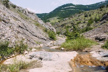 Beautiful mountain stream among the hills on a summer day