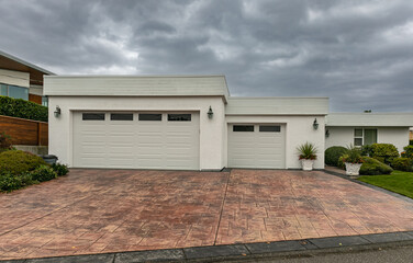 Residential house two car garage. Modern and luxurious double garage with driveway and roller door