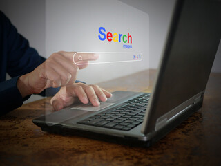A man is using a notebook computer to searching for information. A virtual screen of the Search...