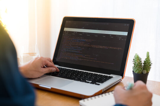 Programer developer coding software about intelligence innovation. Young man programmer writes program code on a computer. home office .