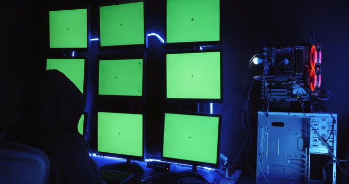 A male hacker is using a computer to hack data to demand ransom from victims.