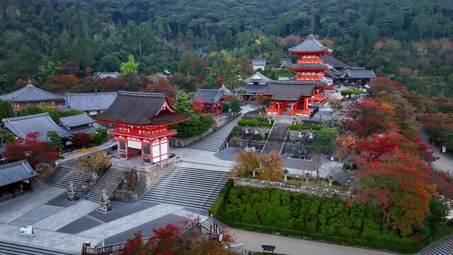 Kyoto buddhist temple aerial view, famous Kiyomizudera temple in Kyoto, Japan, in autumn, red historic pagodas of a religious Asian building