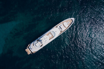 Big White Mega yacht is anchored on clear water, top view. Super yachts in the sea top view.