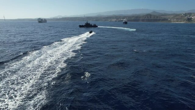 Fantastic aerial shot of a speeding boat of the national police approaching a police patrol boat. National customs police against drug trafficking.