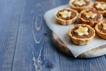 Christmas mince pies with fruit filling on a gray background.