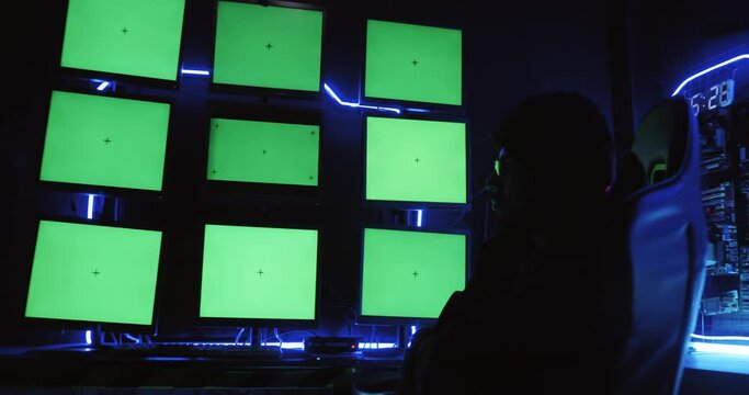 A male hacker is using a computer to hack data to demand ransom from victims.