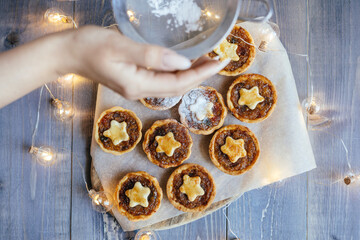Christmas mince pies with fruit filling on a gray background.