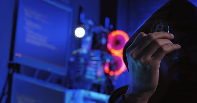 A male hacker is using a computer to hack data to demand ransom from victims.	