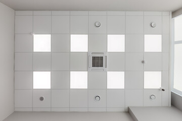 cassette stretched or suspended ceiling with square halogen spots lamps and drywall construction with fire alarm and ventilation in empty room in house or office. Looking up view