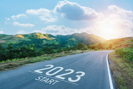 Happy new year 2023,2023 symbolizes the start of the new year. The letter start new year 2023 on the road in nature route roadway sunrise have tree environment ecology or greenery wallpaper concept.