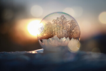 Frozen frost bubble on cold winters snow producing crystal design formations as it freezes.