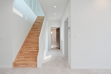It is a staircase going up to the second floor, and it was made of wood material, giving a point to the house with an overall white interior