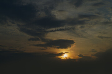 Summer evening sky in the picturesque clouds, lit by the rays of the setting sun.
