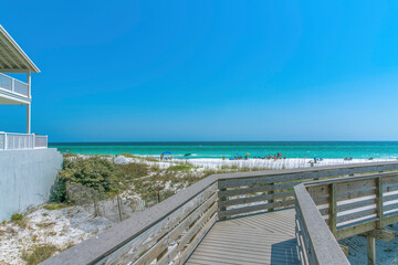 View of the beach with tourists on the shore from a boardwalk at Destin, Florida