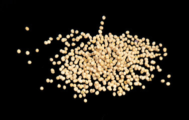 Soy Bean flying explosion, yellow grain beans explode abstract cloud fly. Beautiful complete seed pea soy bean splash in air, food object design. Selective focus freeze shot black background isolated