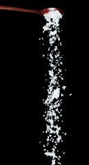 Obraz premium Salt fall, crystal white grain peanuts explode abstract cloud fly from wooden spoon. Beautiful complete seed salt, food object design. Selective focus freeze shot black background isolated