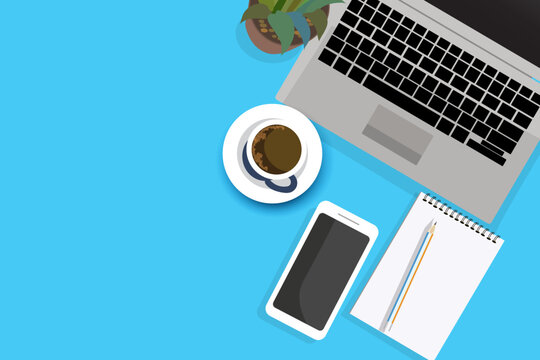 Creative flat lay of workspace desk. Top view office desk with laptop, notebooks, mobilephone and coffee cup on blue color background. Top view with copy space