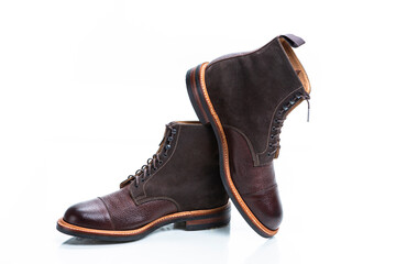 Pair of Premium Dark Brown Grain Brogue Derby Boots Made of Calf Leather with Rubber Sole Placed Over One Another Over White