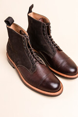 Premium Dark Brown Grain Brogue Derby Boots Made of Calf Leather with Rubber Sole Placed Over Beige