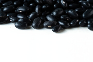 Pile set of black bean, black grain beans pouring down abstract cloud group. Beautiful complete seed pea bean, food object design. Selective focus freeze shot white background isolated