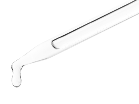 A drop of liquid falls from a glass pipette