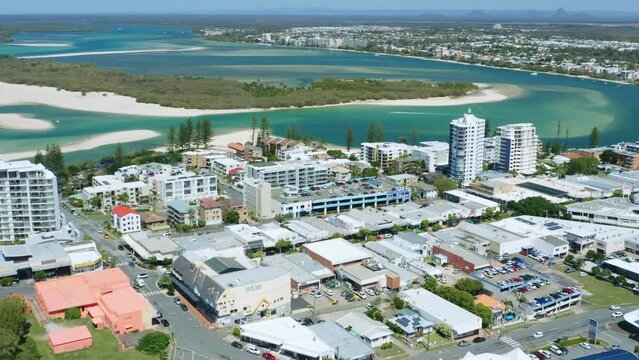 Aerial Drone Above Small Coastal Town With Blue Water Inlet And Waterfront Buildings, 4K