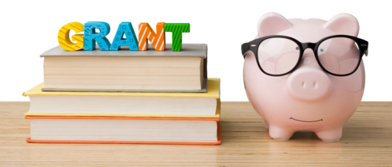 Piggy bank with books on desk