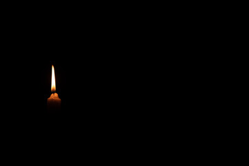 Burning candle seen in dark