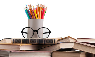 Colorful pen in glass on stack books