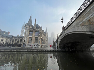 Scenic view of the city of Ghent (Belgium) with bridge and canal in the morning mist