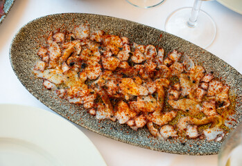 Appetizing seafood carpaccio from thinly sliced octopus tentacles drizzled with smoked paprika and olive oil