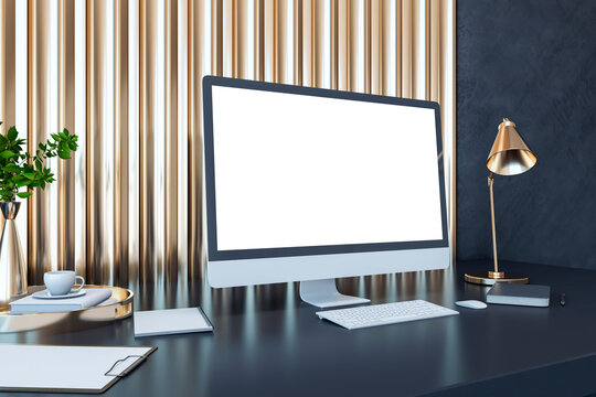 Perspective view on blank white computer monitor with empty place on dark work table with notebook, flower coffee pot on golden slatted decorative wall panel background. 3D rendering, mockup