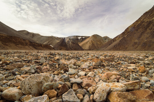 Close up rocks on ground concept photo. Picturesque highland. Front view photography with old mountains on background. High quality picture for wallpaper, travel blog, magazine, article