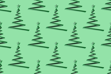 Fototapeta premium Seamless pattern with creative geometric christmas tree on green background with star. Christmas wallpaper or bed linen print. Marketing material. Website banner concept.